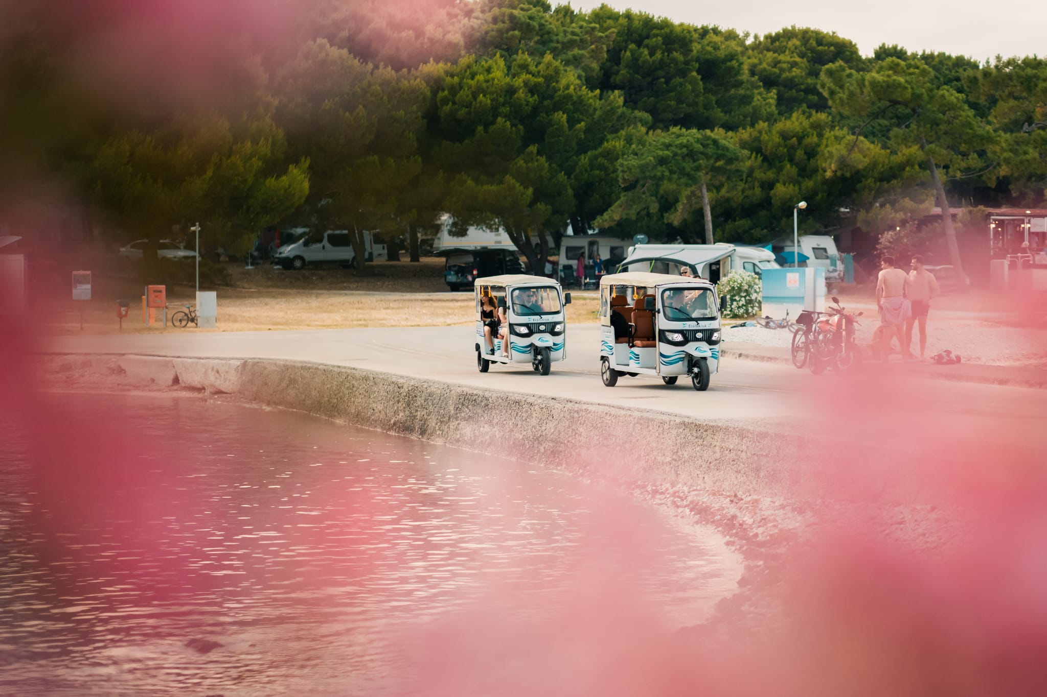 Two tuk-tuks on a group tour along the Camp Medulin waterfront